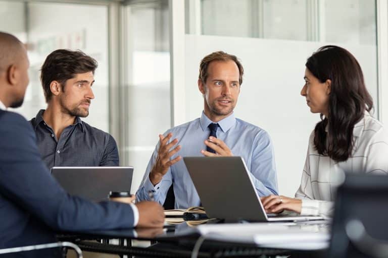 Businessman giving some new ideas about project to his partners in conference room.